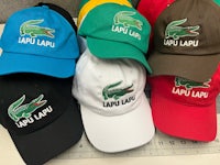 a group of hats with the word lacoste on them